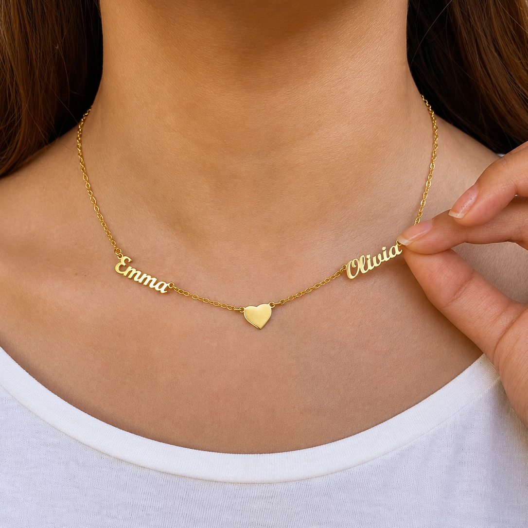 Gold necklace with name pendants on a person wearing a white shirt.