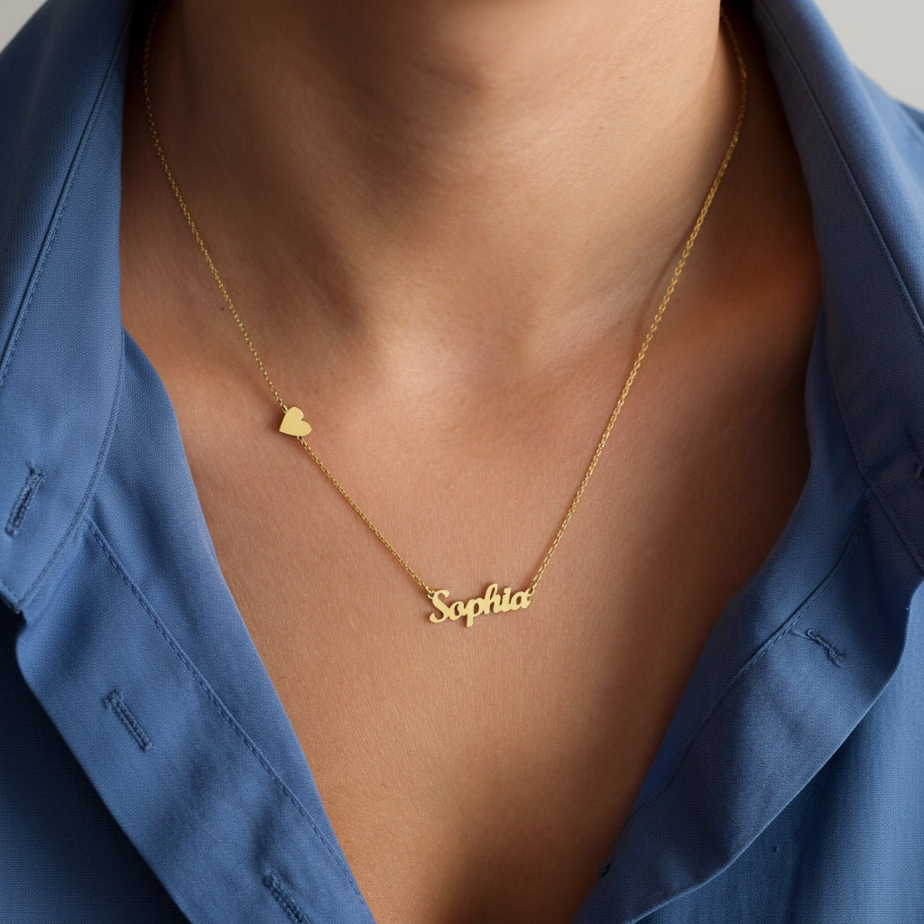 Gold necklace with 'Sophia' pendant on a person wearing a blue shirt